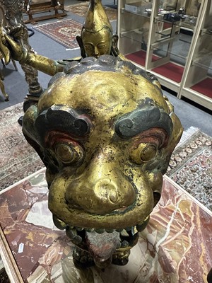Lot 32 - Pair of 18th century Tibetan repousse copper snow lions with deities