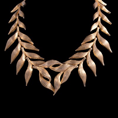 Lot 473 - Elsa Schiaparelli - a signed gold tone leaf design necklace.