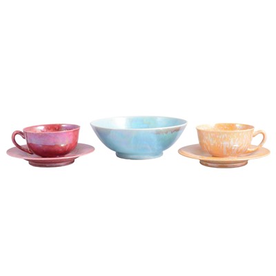 Lot 8 - Ruskin, two lustre cups and saucers, and a lustred bowl (attributed)
