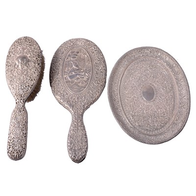 Lot 304 - CATALOGUE AMENDMENT White metal-BACKED three-piece dressing table set, possibly Ragavaji Mawji.