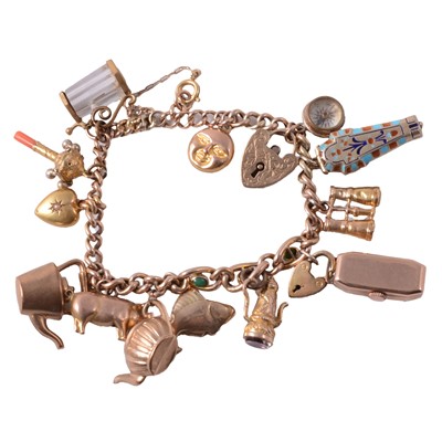 Lot 296 - A yellow metal hollow curb link bracelet with charms.