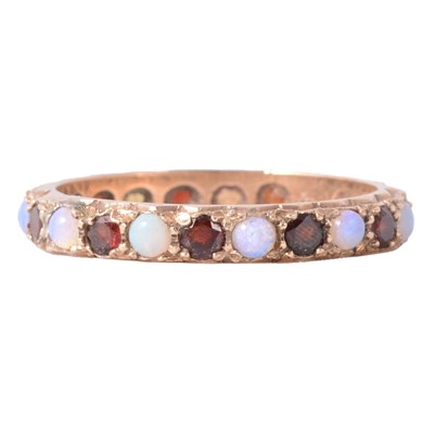 Lot 53 - A garnet and opal eternity ring.