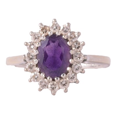 Lot 235 - An amethyst and diamond cluster ring.