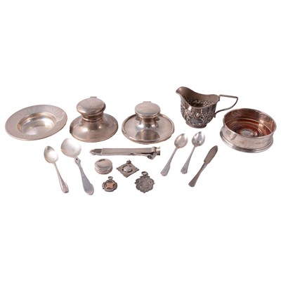 Lot 335 - Two silver capstan inkwells, flatware, bottle coaster, cream jug, and other small silver.