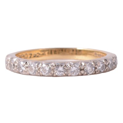 Lot 106 - A diamond half eternity ring.