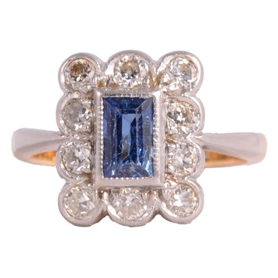 Lot 234 - A sapphire and diamond cluster ring.