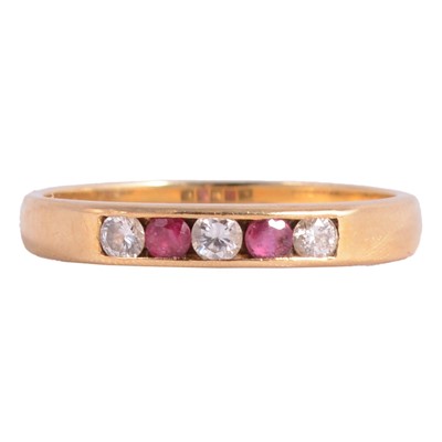 Lot 237 - A ruby and diamond half eternity ring.