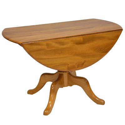 Lot 371 - Ercol beech and elm dining table and four chairs