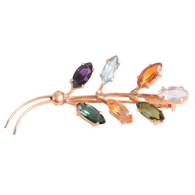 Lot 210 - A yellow metal leaf spray brooch set with seven semi-precious gems.