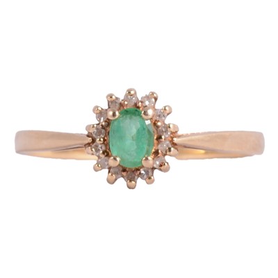Lot 238 - An emerald and diamond cluster ring.