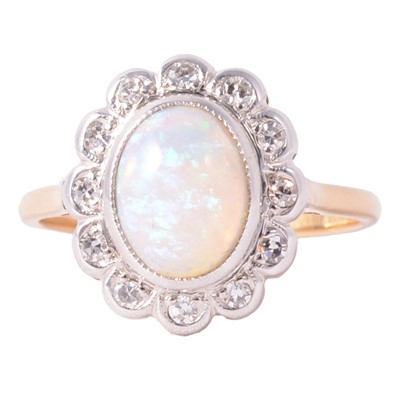 Lot 50 - An opal and diamond oval cluster ring.