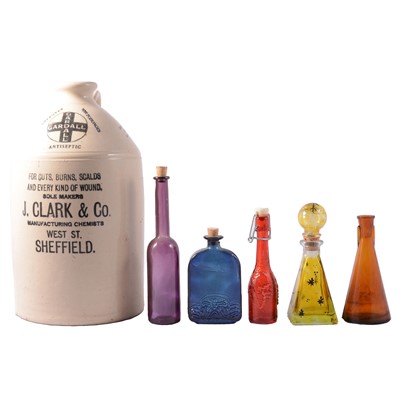 Lot 50 - Collection of coloured glass chemist's bottles and a large stoneware flagon