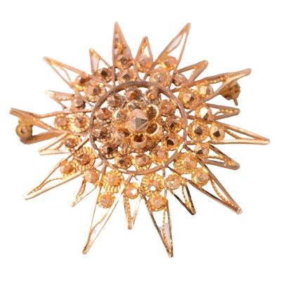 Lot 207 - A yellow metal star brooch.