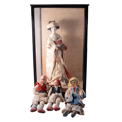 Lot 87 - Large Japanese Geisha doll in display case, and three Greek travel dolls