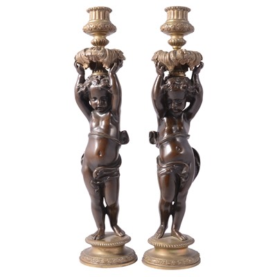 Lot 75 - Pair of bronze and cast brass figural candlesticks