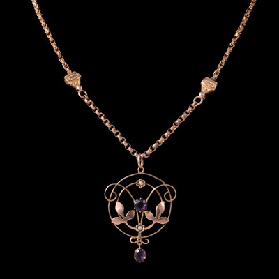 Lot 243 - An amethyst and seed pearl pendant on a yellow metal chain.