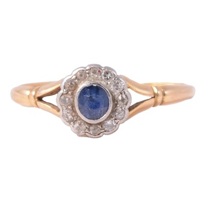 Lot 10 - A sapphire and diamond cluster ring.