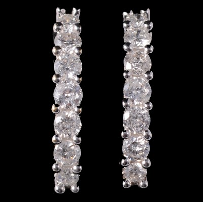 Lot 180 - A pair of diamond hoop earrings.