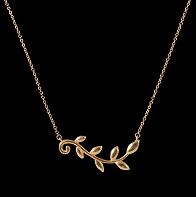Lot 236 - Paloma Picasso for Tiffany - an 18 carat yellow gold Olive Leaf Vine pendant.