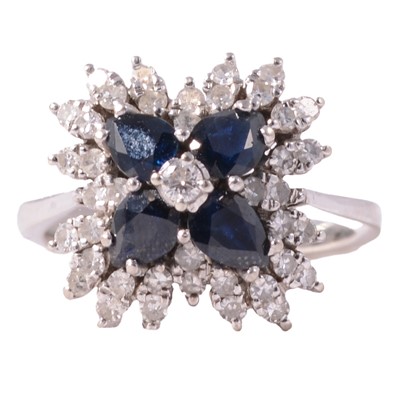 Lot 7 - A sapphire and diamond floral cluster ring.