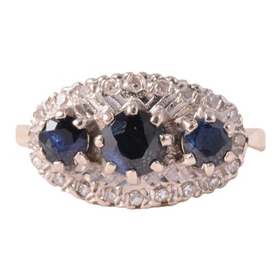 Lot 11 - A sapphire and diamond boat shaped cluster ring.