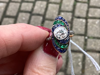 Lot 20 - An Art Deco diamond ring with emerald and sapphire surround.