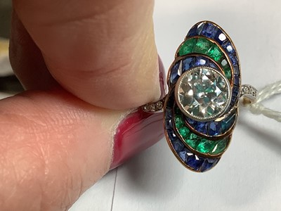 Lot 20 - An Art Deco diamond ring with emerald and sapphire surround.