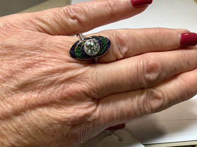 Lot 20 - An Art Deco diamond ring with emerald and sapphire surround.