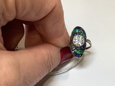 Lot 20 - An Art Deco diamond ring with emerald and sapphire surround.
