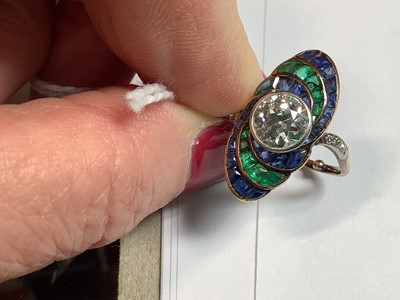 Lot 20 - An Art Deco diamond ring with emerald and sapphire surround.