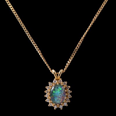 Lot 250 - An opal triplet and diamond pendant on a chain.
