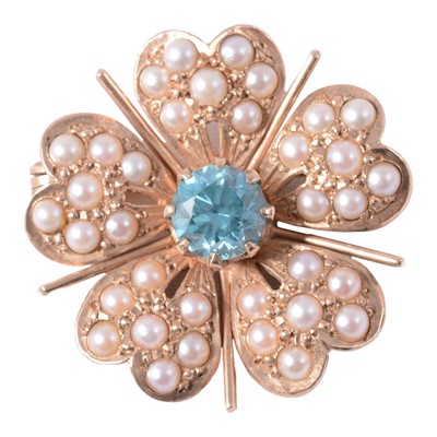 Lot 217 - A heat treated blue zircon and pearl floral design brooch.