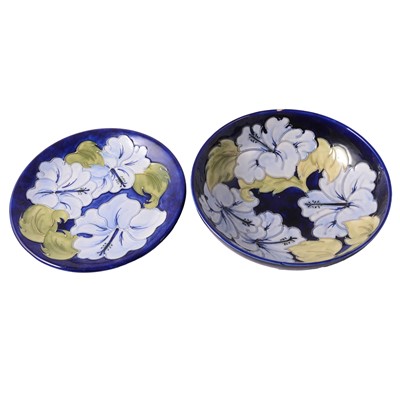 Lot 103 - Moorcroft Pottery, a 'Hibiscus' pattern bowl and plate, 1970s