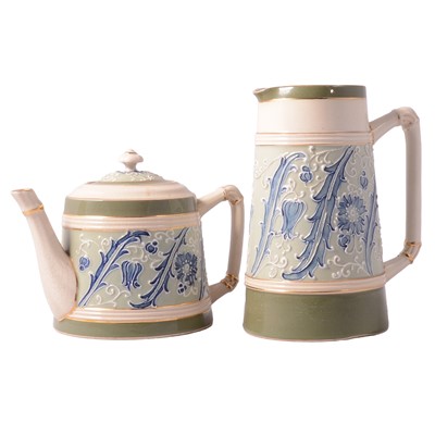 Lot 105 - James Macintyre 'Gesso Faience' ware teapot and hotwater jug, the design attributed to William Moorcroft