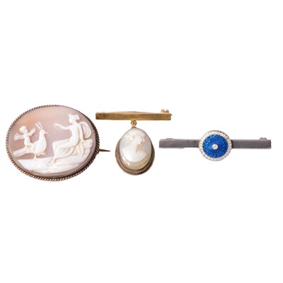 Lot 228 - Two carved shell cameo brooches, and a silver and enamel button brooch.