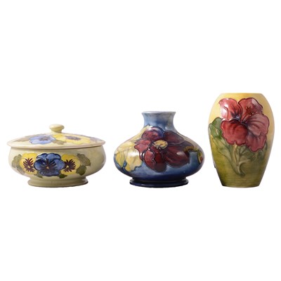 Lot 44 - Moorcroft Pottery, an 'Hibiscus' vase, 'Pansy' powder bowl and cover, and 'Anemone' vase