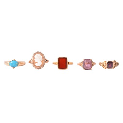 Lot 115 - Four gemset dress rings, and a carved shell cameo ring.