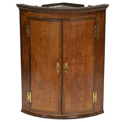 Lot 440 - George III oak and mahogany banded cylinder front corner cupboard