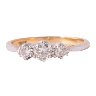Lot 75 - A diamond three stone ring.