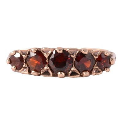 Lot 45 - A garnet five stone ring.