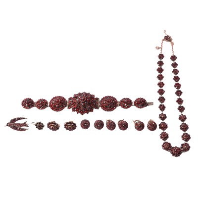Lot 455 - A garnet necklace, bracelet, earrings, brooch, and buttons in closed back settings.
