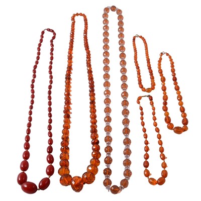 Lot 333 - A red cherry amber-coloured bead necklace, and five other amber-coloured bead necklaces.