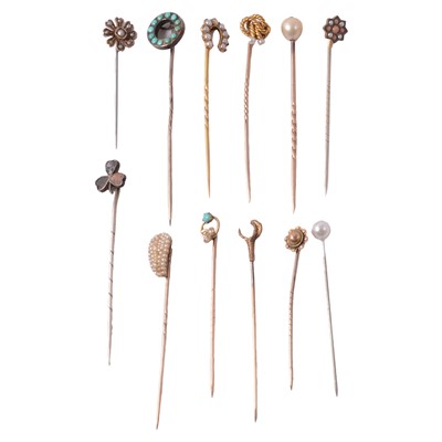 Lot 348 - Twelve stick pins, seed pearl, turquoise, and others.