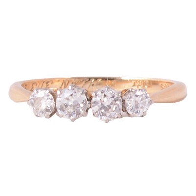 Lot 86 - A diamond four stone ring.