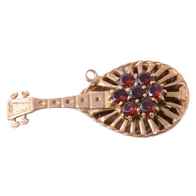 Lot 247 - A garnet set mandolin pendant.