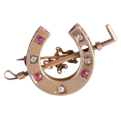 Lot 198 - A ruby and diamond horseshoe and riding crop brooch.