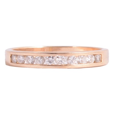 Lot 104 - A diamond half eternity ring.