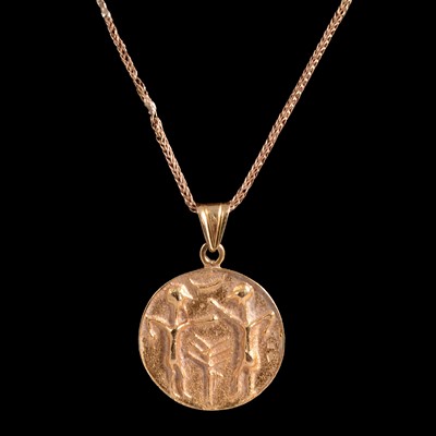 Lot 238 - A yellow metal pendant on a chain.
