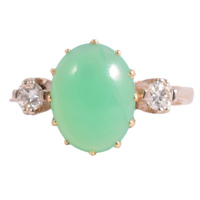 Lot 30 - A diamond and green stone ring.