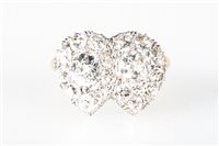 Lot 166 - A diamond heart design cluster ring, the two...